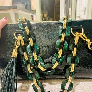 Elegant Black Crossbody Bag with Green and Gold Accents